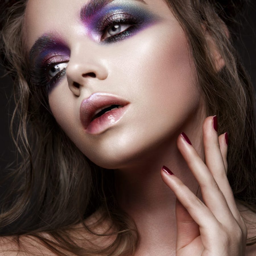 Beautiful young model with bright make-up and manicure