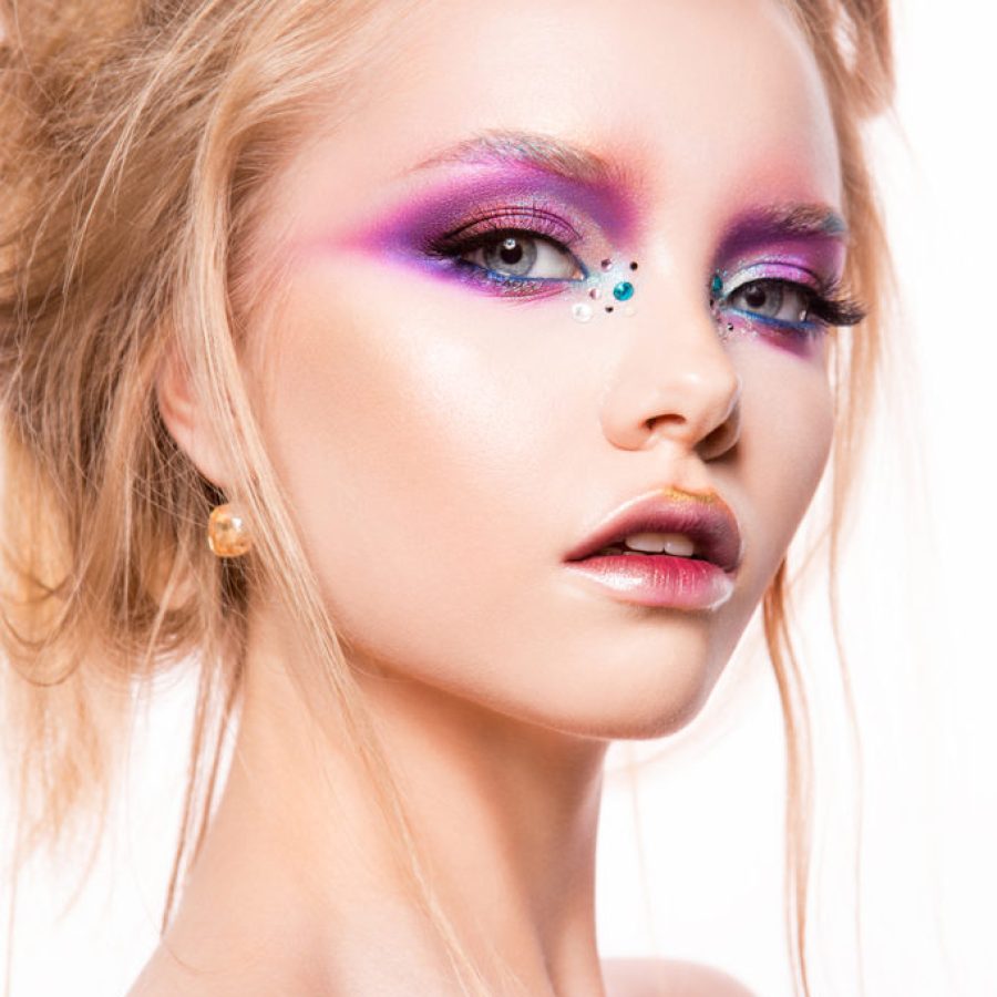 Beautiful young model with bright make-up and manicure