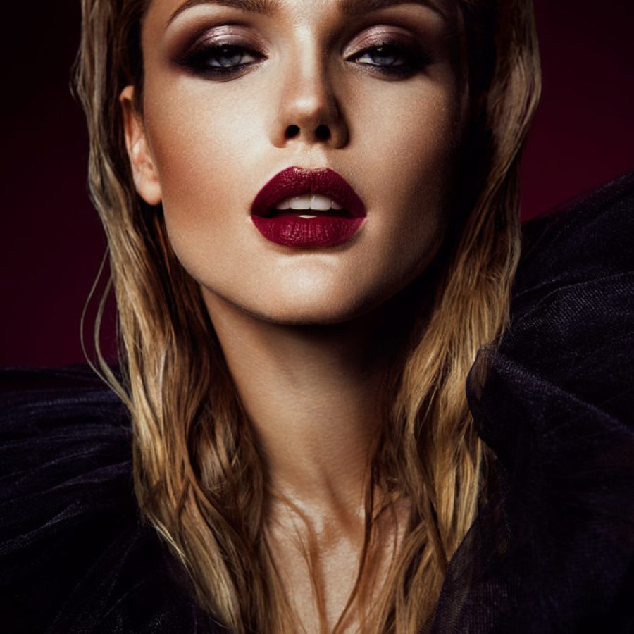 Close-up portrait of beautiful woman with bright make-up and red lips